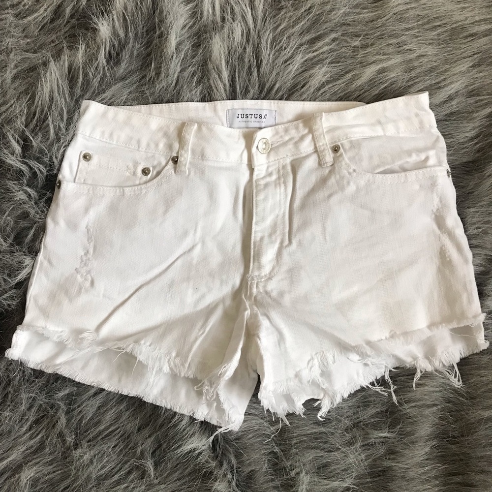 White denim shorts with frayed bottoms